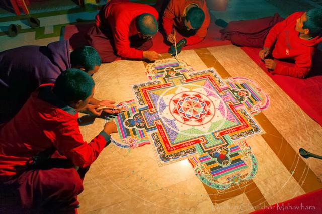 3-Dechen Choekhor Monks in the process of making the Sand Mandala of Chakrasamvara with full concentration.jpg
