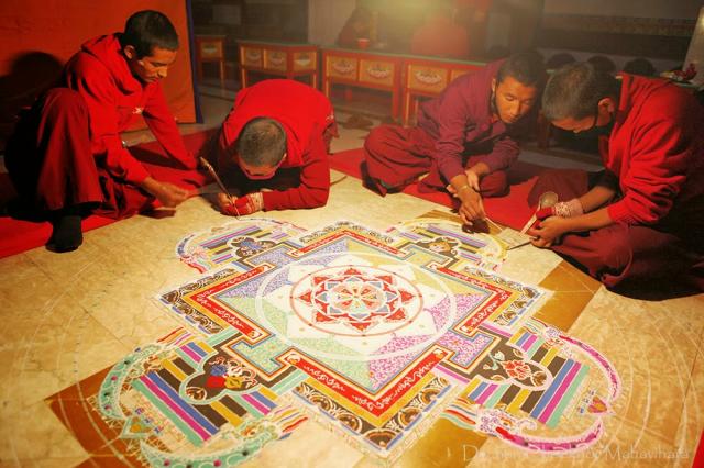 2-Dechen Choekhor Monks in the process of making the Sand Mandala of Chakrasamvara with full concentration.jpg