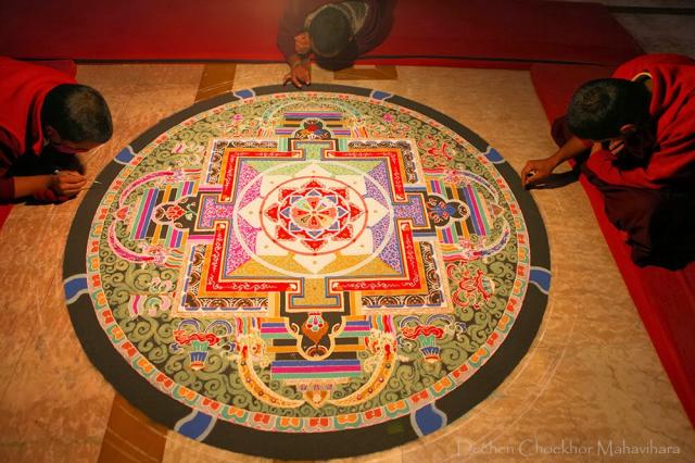 4-Dechen Choekhor Monks in the process of making the Sand Mandala of Chakrasamvara with full concentration.jpg